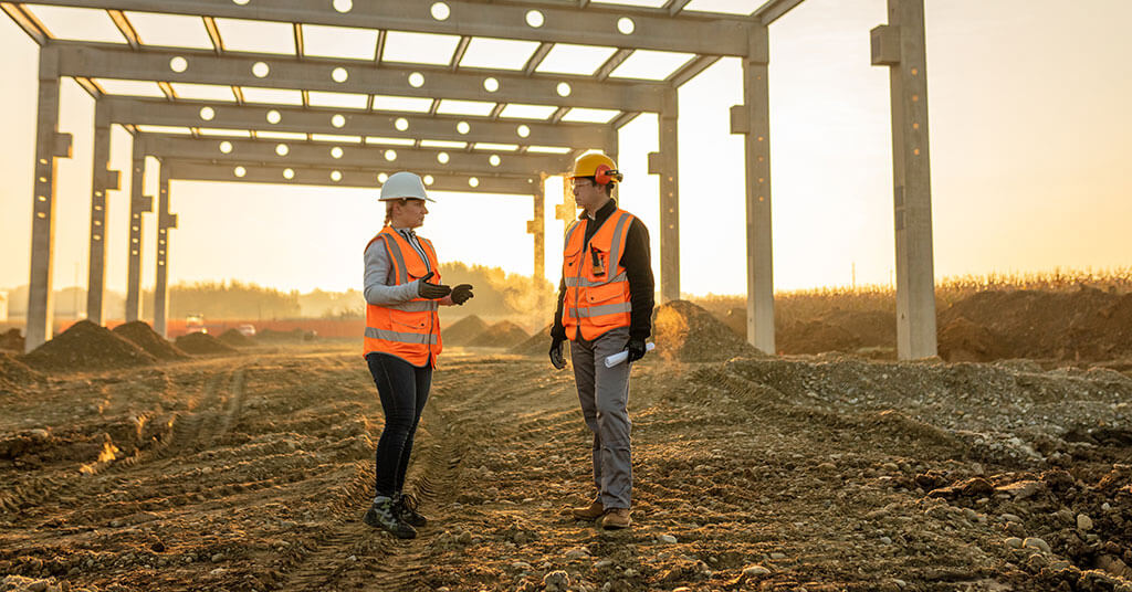 Construction employees talking together